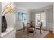 A bright dining room with a round table and a large window that provides natural light at 8406 Wheatstone Ln, Raleigh, NC 27613