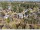 Aerial view of a house near a river, surrounded by mature trees, offering a serene and private setting at 126 E Drewry Ln, Raleigh, NC 27609