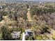 Aerial view of the property surrounded by lush greenery at 126 E Drewry Ln, Raleigh, NC 27609