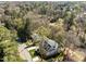 Aerial view of a house nestled in a lush green neighborhood with mature trees and landscaping at 126 E Drewry Ln, Raleigh, NC 27609
