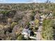 Drone shot of a beautiful house surrounded by lush trees, combining city and suburban living at 126 E Drewry Ln, Raleigh, NC 27609
