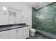 Stylish bathroom with dark countertops, modern shower stall, and accent lighting at 126 E Drewry Ln, Raleigh, NC 27609