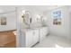 Bright bathroom features double vanity, marble countertops, stylish sconces, and oval mirrors at 126 E Drewry Ln, Raleigh, NC 27609