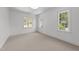 Bright, carpeted bedroom with three large windows, offering plenty of natural light at 126 E Drewry Ln, Raleigh, NC 27609