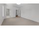Open bedroom offers two doorways, neutral carpet and trim, and a view of the bathroom at 126 E Drewry Ln, Raleigh, NC 27609