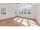 Bright, airy bedroom with hardwood floors, white walls, and plenty of natural light at 126 E Drewry Ln, Raleigh, NC 27609