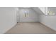 Neutral-toned bedroom with carpet, two windows, and an attic ceiling at 126 E Drewry Ln, Raleigh, NC 27609