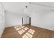 Spacious bedroom with hardwood floors, white walls, and natural light at 126 E Drewry Ln, Raleigh, NC 27609