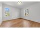 Bright bedroom featuring hardwood floors, ample natural light, and a neutral color palette at 126 E Drewry Ln, Raleigh, NC 27609