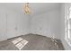 Bonus room with grey concrete flooring, modern chandelier and natural light from the windows at 126 E Drewry Ln, Raleigh, NC 27609
