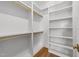 Spacious walk-in closet with built-in shelves and rods offering organized storage solutions at 126 E Drewry Ln, Raleigh, NC 27609
