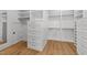 Custom walk-in closet with built-in shelving, drawers, and hanging rods providing ample storage space at 126 E Drewry Ln, Raleigh, NC 27609