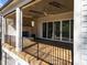 Covered outdoor deck with brick fireplace, ceiling fan, and sliding doors offering a seamless indoor-outdoor flow at 126 E Drewry Ln, Raleigh, NC 27609