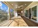 Expansive outdoor deck featuring a brick fireplace, ceiling fan, and picturesque views of the surrounding landscape at 126 E Drewry Ln, Raleigh, NC 27609