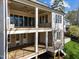 Back exterior elevation of the home featuring brick and vinyl, multiple patios and railings at 126 E Drewry Ln, Raleigh, NC 27609