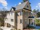 Charming two-story brick home featuring gray shutters, a covered entrance, and a well-manicured lawn at 126 E Drewry Ln, Raleigh, NC 27609