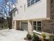 Exterior shot of the home featuring a grey garage door, a brick and vinyl exterior and concrete driveway at 126 E Drewry Ln, Raleigh, NC 27609
