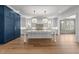 Spacious white kitchen with a large island, stainless appliances, and a walk through to the living room at 126 E Drewry Ln, Raleigh, NC 27609