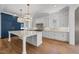 Spacious white kitchen with a large island, stainless appliances, and abundant storage at 126 E Drewry Ln, Raleigh, NC 27609