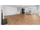 Open-concept living area featuring hardwood floors, a fireplace, and a seamless flow to the kitchen at 126 E Drewry Ln, Raleigh, NC 27609