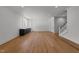 Spacious living area with hardwood floors, wet bar and mini-fridge, bright lighting, and open stairway at 126 E Drewry Ln, Raleigh, NC 27609