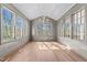 Bright living room with hardwood floors, chandelier, and large windows offering ample natural light at 126 E Drewry Ln, Raleigh, NC 27609