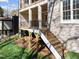 Exterior shot of a home featuring a staircase with iron railings, brick exterior and manicured landscaping at 126 E Drewry Ln, Raleigh, NC 27609