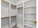 Custom white walk-in closet with carpeted floors and wooden rods and shelving at 126 E Drewry Ln, Raleigh, NC 27609