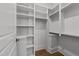 Bright walk-in closet with white shelving and metal rods at 126 E Drewry Ln, Raleigh, NC 27609
