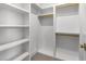 White walk-in closet featuring wood rods and built-in shelves at 126 E Drewry Ln, Raleigh, NC 27609
