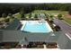 Aerial view of community pool, clubhouse, tennis courts, and playground at 143 High Ridge Ln, Pittsboro, NC 27312