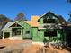 Two-story house under construction, featuring a large front porch and a gable roof at 143 High Ridge Ln, Pittsboro, NC 27312