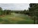 Elevated view of a lush green golf course with surrounding trees and distant homes at 143 High Ridge Ln, Pittsboro, NC 27312