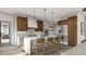 Modern kitchen with island, stainless steel appliances, and wood cabinets at 143 High Ridge Ln, Pittsboro, NC 27312