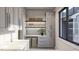 Bright laundry room with ample cabinetry and counter space at 143 High Ridge Ln, Pittsboro, NC 27312