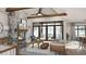 Cozy living room features a stone fireplace and access to a deck at 143 High Ridge Ln, Pittsboro, NC 27312