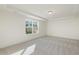 Bright and airy bedroom with neutral carpeting and large window at 182 Ford Meadows Dr, Garner, NC 27529