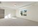 Large bedroom with window and carpet flooring at 182 Ford Meadows Dr, Garner, NC 27529