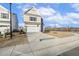 Two-story house with beige siding, stone accents, and a two-car garage at 182 Ford Meadows Dr, Garner, NC 27529