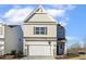 Two-story house with beige siding, stone accents, and a two-car garage at 182 Ford Meadows Dr, Garner, NC 27529