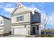 Two-story house with beige siding, stone accents, and a two-car garage at 182 Ford Meadows Dr, Garner, NC 27529