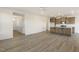 Open concept living room with hardwood floors, fireplace, and kitchen island at 182 Ford Meadows Dr, Garner, NC 27529