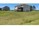 A large backyard features lush green grass and a beautiful home with a back porch at 23 Quail Pt Cir, Clayton, NC 27520