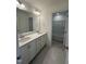 Bright bathroom with double sink vanity, large mirror, and separate bath and shower at 23 Quail Pt Cir, Clayton, NC 27520