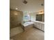This bathroom features a glass-enclosed shower, a soaking tub, and bright recessed lighting at 23 Quail Pt Cir, Clayton, NC 27520