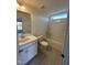 Bathroom features tile floor, single sink vanity, bathtub, shower, and window for natural light at 23 Quail Pt Cir, Clayton, NC 27520