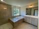 Luxurious bathroom with a freestanding tub, tiled shower, and stylish vanity at 23 Quail Pt Cir, Clayton, NC 27520