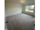 A bright bedroom features a window, neutral carpet, and ample natural light, enhancing the inviting atmosphere at 23 Quail Pt Cir, Clayton, NC 27520