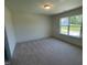 Bedroom featuring plush carpeting and a large window, great natural light at 23 Quail Pt Cir, Clayton, NC 27520