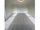 Spacious bedroom featuring double door entrance, recessed lighting, and plush neutral carpeting at 23 Quail Pt Cir, Clayton, NC 27520